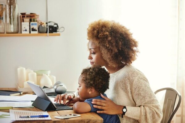 Mother running her business from home with a child